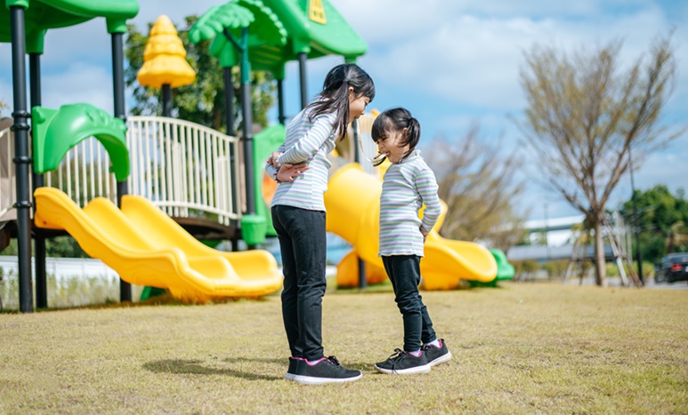 Two Girls Happily Playing Playground